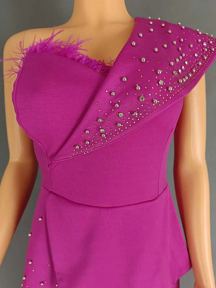 Purple dress with feathered shoulder details on a mannequin against a gray background